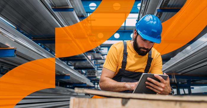 a man in a hard hat looking at a tablet